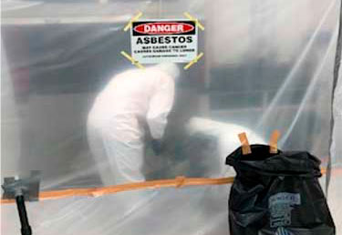 Worker performing asbestos and LBP abatement at a housing complex in Okinawa, Japan