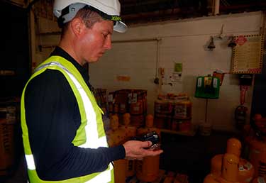 Certified Industrial Hygienist (CIH) measuring indoor air quality in a wood storage warehouse in Okinawa, Japan