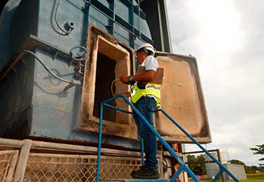 Environmental Engineer evaluating using gas meter before entering solid waste boiler in Okinawa, Japan