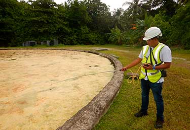 Environmental Engineer measuring gas emisions at a solid waste landfill in Okinawa, Japan